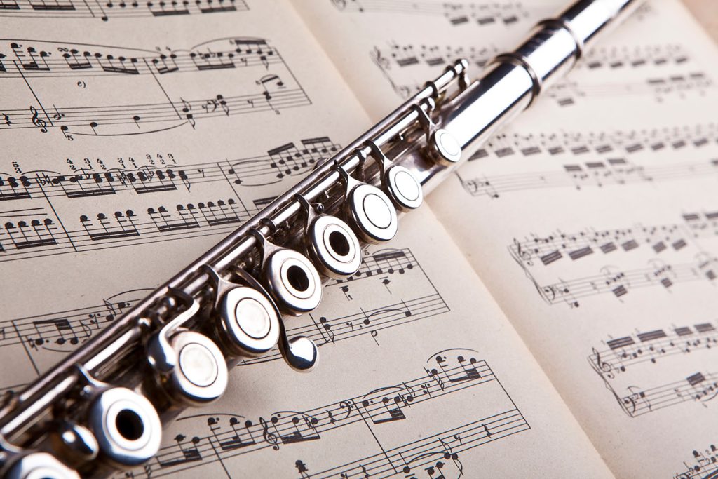 Flute across musical notes for Flute Lessons in Leeds