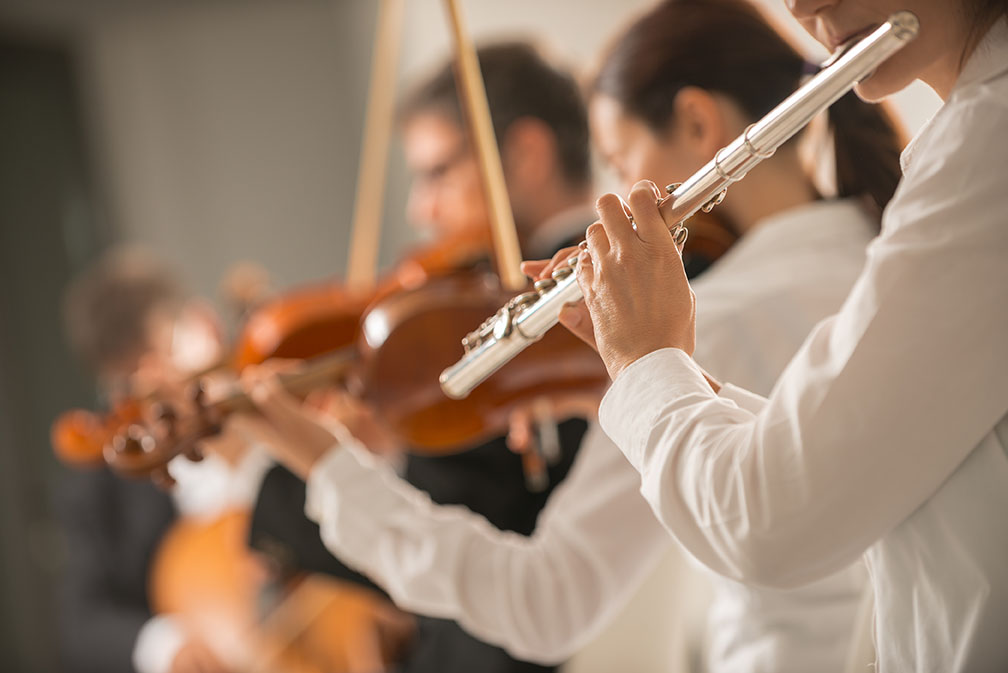 People in white shirts practicing flute lessons in bradford