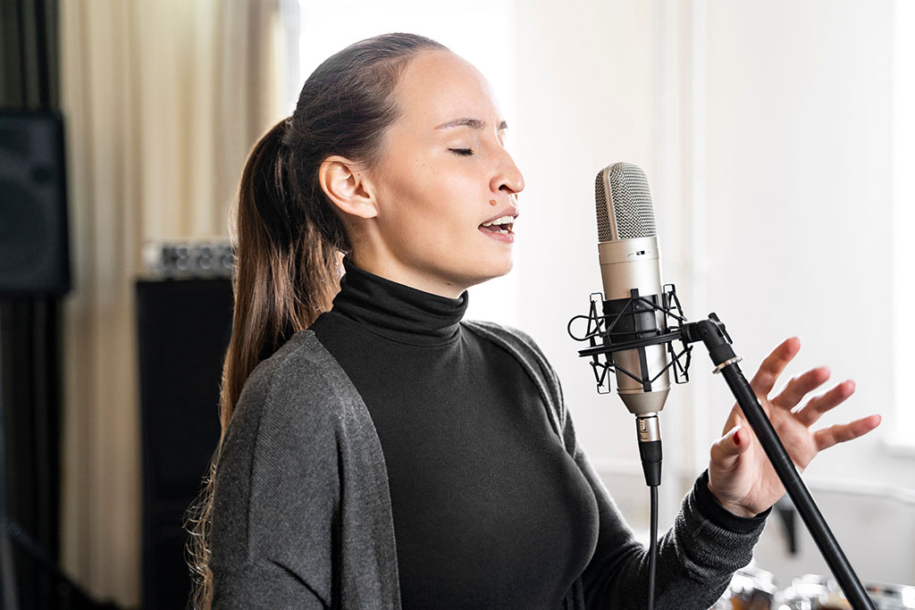 young asian lady receiving online singing lessons in Brighouse