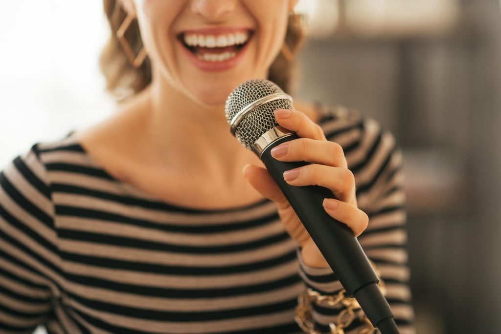 Vocal Coach in Leeds singing into microphone