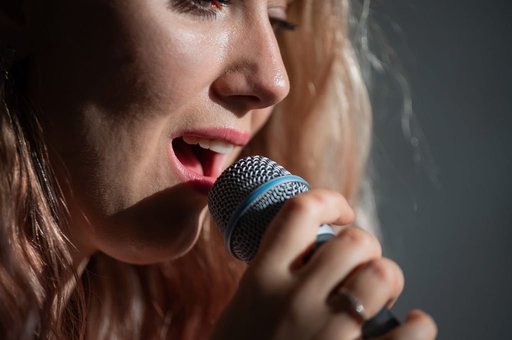 Lady receiving singing lessons in holmfirth