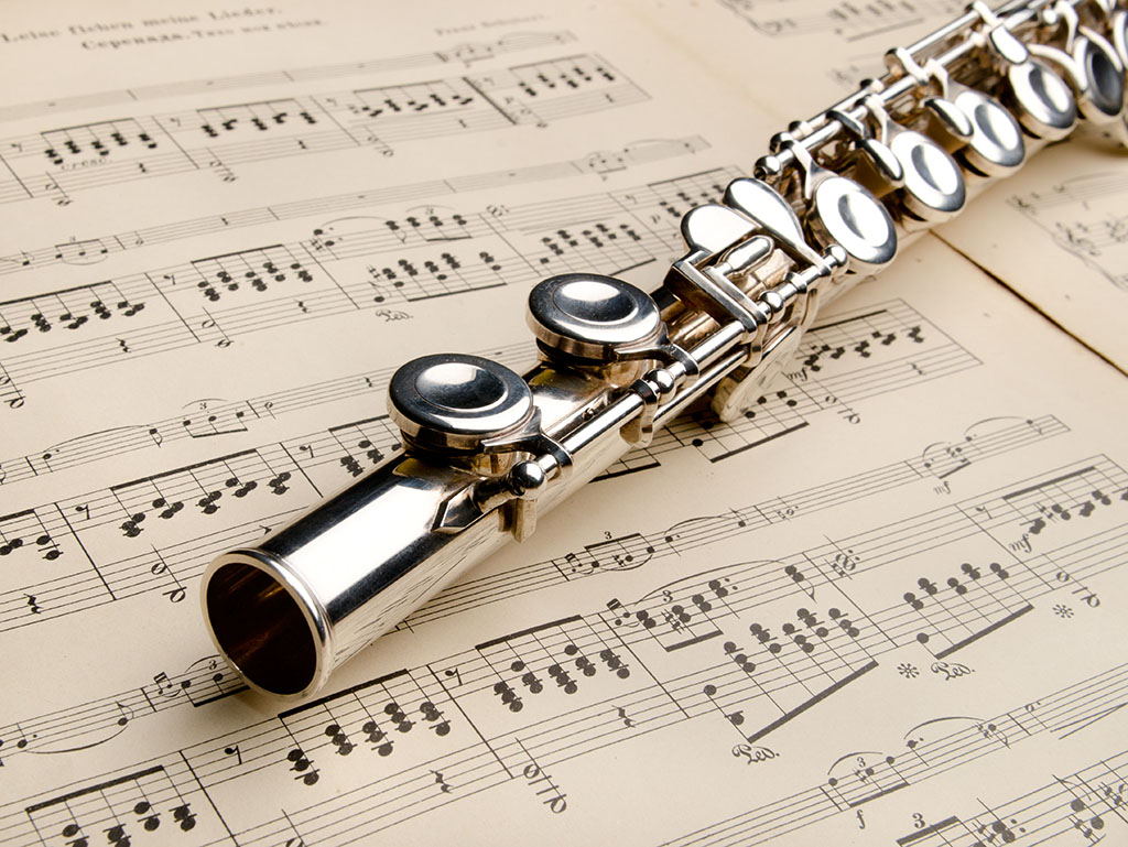 Flute Teacher in Hebden Bridge reading music notes under a flute