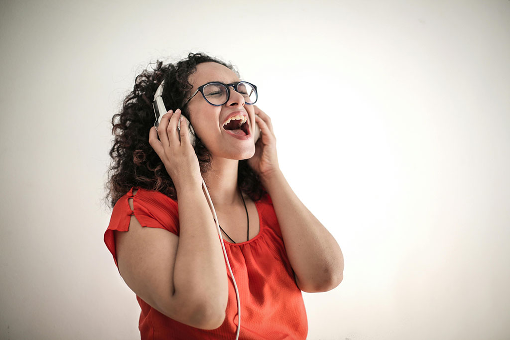 Lady in red jumper receiving vocal coaching in Barnsley