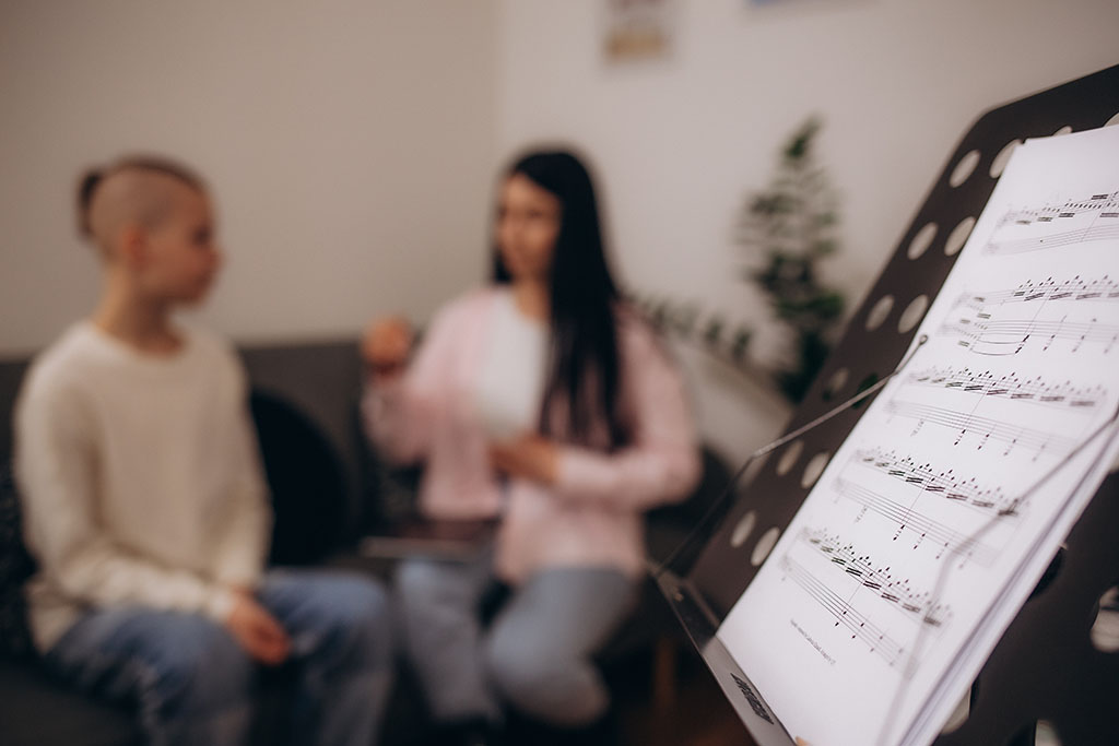 Vocal coach in Wakefield giving a boy in class singing lessons